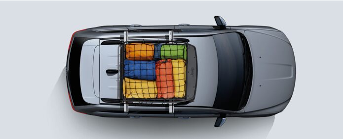 A top-down view of a 2021 Jeep Grand Cherokee carrying several pieces of luggage in a rooftop storage bin.
