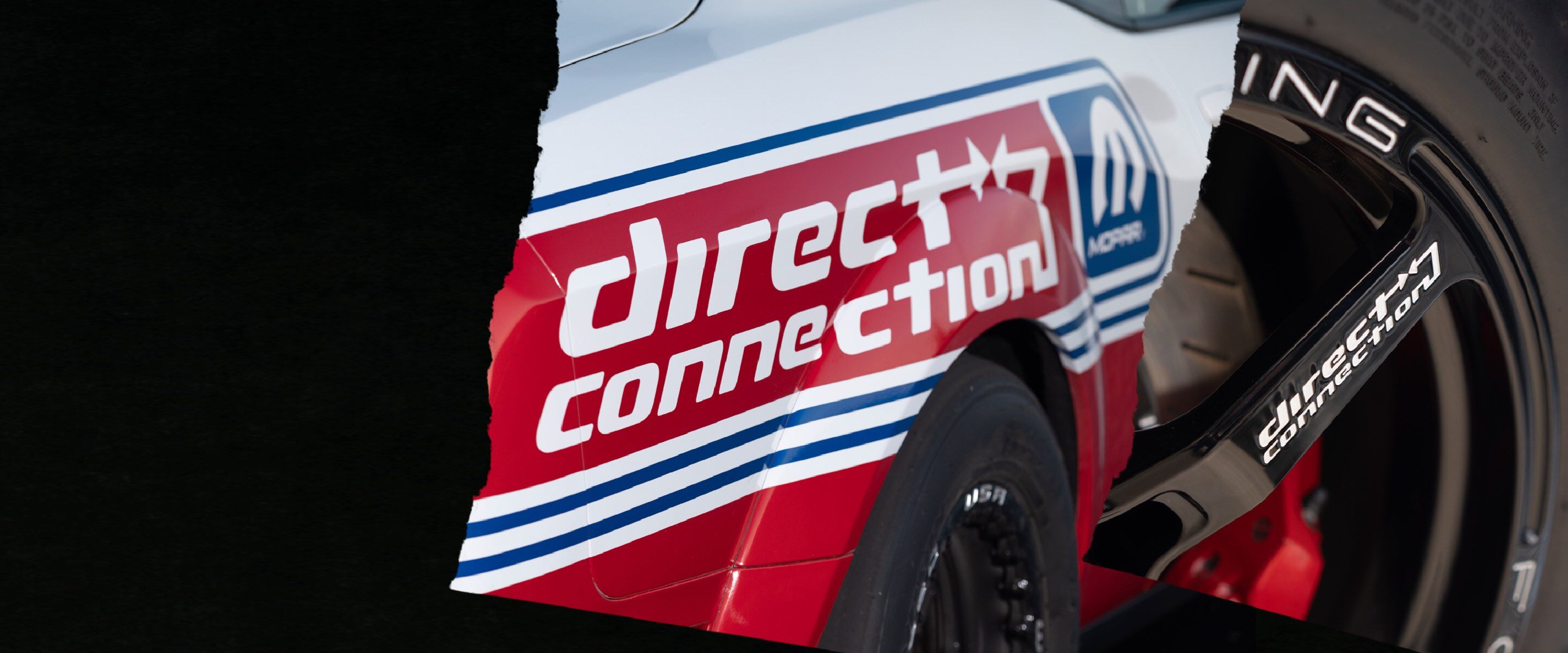 A close-up of a racecar with a Mopar Direct Connection decal on the side.