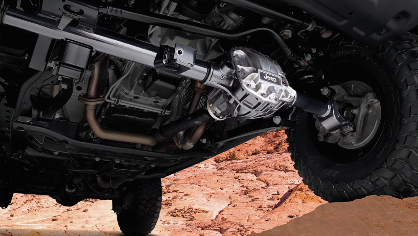 Jeep Wrangler underbody with front axle highlighted in the sun