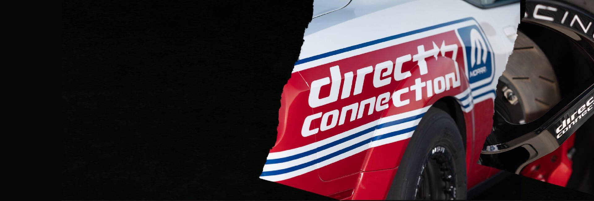 A close-up of a racecar with a Mopar Direct Connection decal on the side.